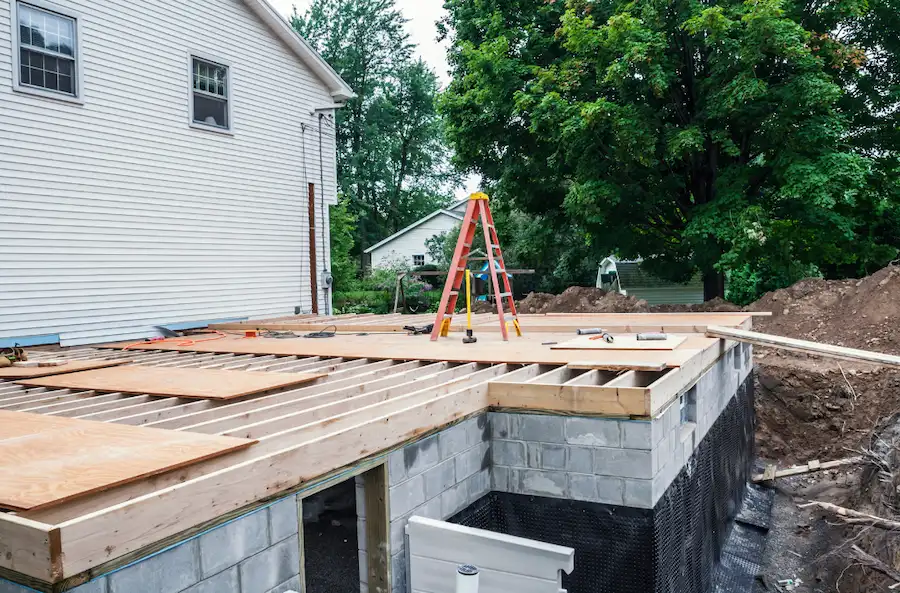 Home addition construction with framed wooden floor, ready for the next phase of the project.